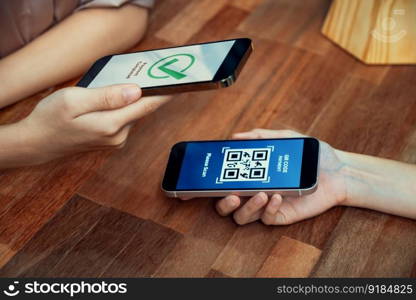 QR code is displayed on screen for cashless payment scanning. Closeup hands hold smartphone to transfer money by electronic transaction from mobile app. Bar code technology for fast pay. Enthusiastic. QR code is displayed on screen for cashless payment scanning. Enthusiastic