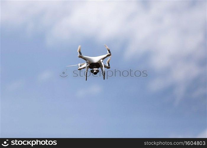 Quadcopter drone in sky. Small drone flies in sky taking video and photos. Remote control air delivery and spy. selective focus. Quadcopter drone in sky. Small drone flies in sky taking video and photos. Remote control air delivery and spy. selective focus.
