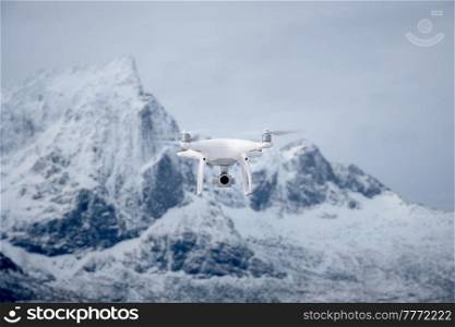 Quadcopter drone with digital camera in mountains. Drone with digital camera