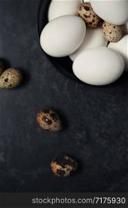 Quail and chicken eggs on a table