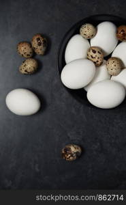 Quail and chicken eggs on a table