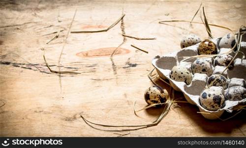 Quail eggs in a cassette. On wooden background.. Quail eggs in a cassette.