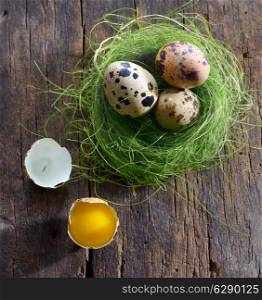 quail eggs in a nest on a wooden background