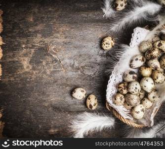 Quail eggs in rustic Basket on dark wooden background, top view
