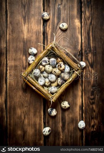 Quail eggs in the basket. On wooden background.. Quail eggs in the basket.