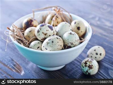 quail eggs in the bowl and on a table