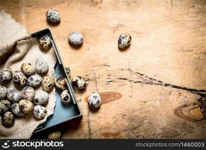 Quail eggs in the box. On wooden background.. Quail eggs in the box.