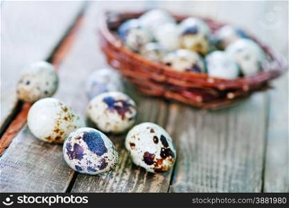 quail eggs on the nest and on the wooden table