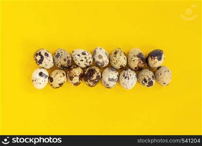 Quail eggs on yellow paper background. Easter concept. Template Creative Flat lay Top view Copy space lettering, text or your design.. Quail eggs on yellow paper background. Easter concept. Template Creative Flat lay Top view Copy space lettering, text or your design