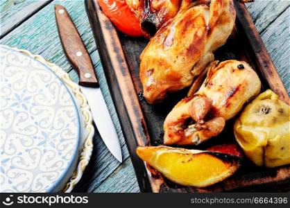 Quail fried with orange and apples.Roasted quail. Delicious fried quail