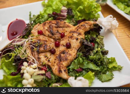 quail roasted with sweet and sour cranberry sauce. quail roasted with sweet and sour cranberry sauce decorated with rowanberry