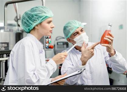 Quality control and food safety team inspection the product standard in the food and drink factory production line.