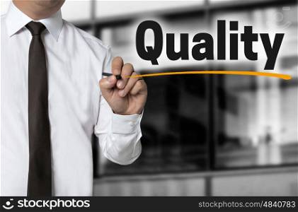 Quality is written by businessman background concept. Quality is written by businessman background concept.