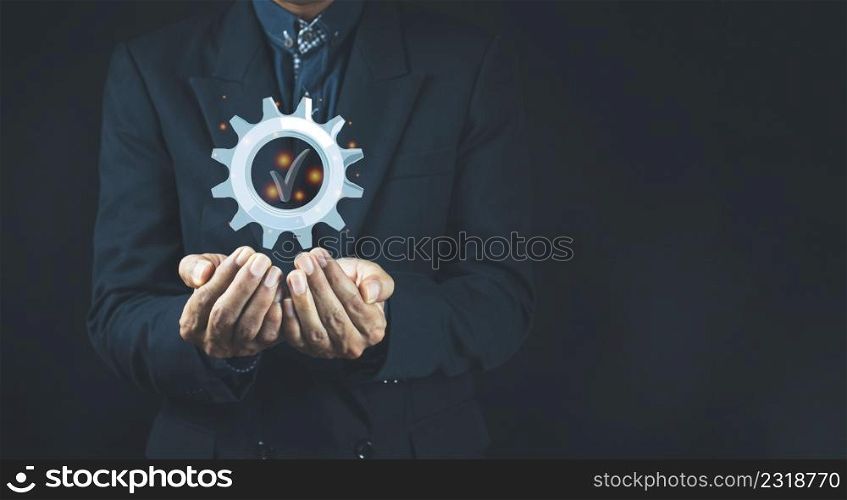 Quality product symbol in the hand of a business man.Hand shows the sign of the top service Quality assurance, Guarantee, Standards, ISO certification and standardization concept.