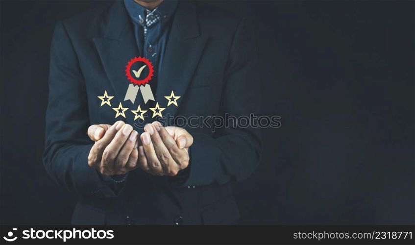 Quality product symbol in the hand of a business man.Hand shows the sign of the top service Quality assurance, Guarantee, Standards, ISO certification and standardization concept.