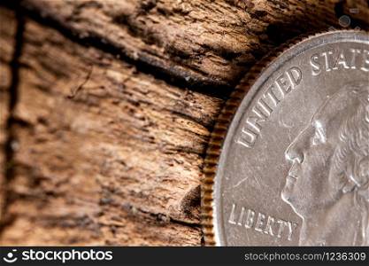 quarter american dollar with George Washington coin closeup on old wooden surface