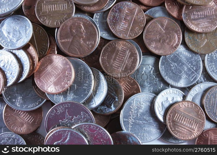 Quarters, dimes, nickels and pennies spread out on the table