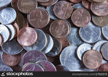 Quarters, dimes, nickels and pennies spread out on the table