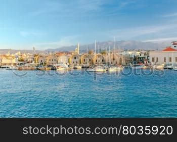 Quay in Chania at sunset.. Old warehouses on the waterfront of the Venetian harbor. Chania. Crete.
