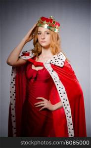 Queen in red dress in studio