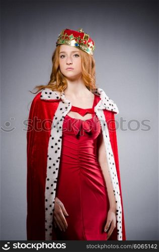 Queen in red dress in studio