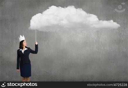 Queen of office. Young businesswoman in paper crown holding balloon cloud
