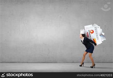 Queen of office. Young businesswoman in paper crown overloaded with documents