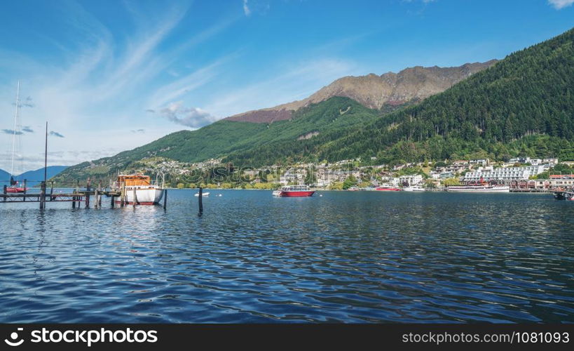 Queenstown lakefront city center shot at Lake Wakapitu, the famous lake of Queenstown, center of tourism, water sport and boat tours, South Island of New Zealand.