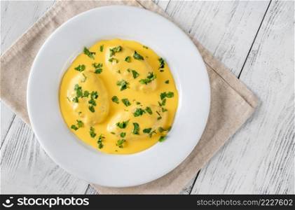 Quenelle - creamed fish mixture  with Hollandaise sauce