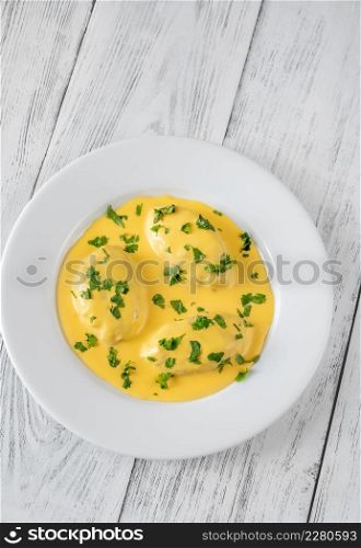 Quenelle - creamed fish mixture with Hollandaise sauce