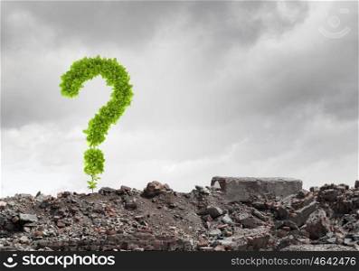 Question concept. Conceptual image with green question mark growing on ruins