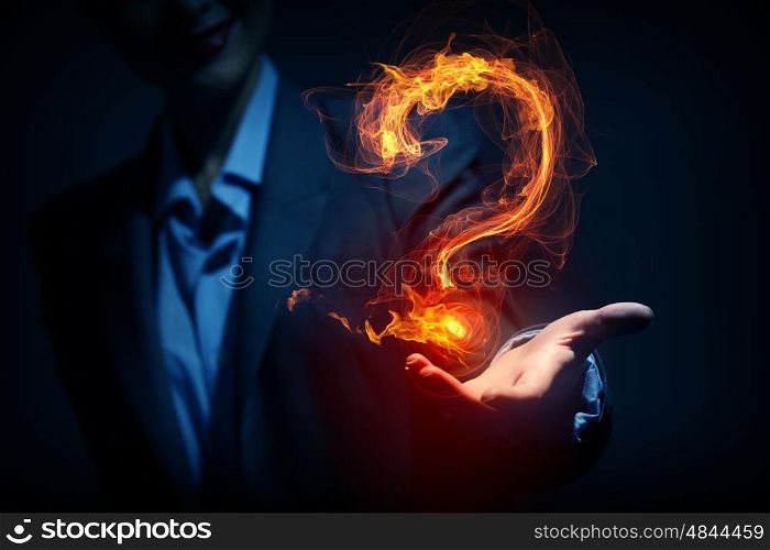 Question light sign. Glowing question mark symbol in palm on dark background