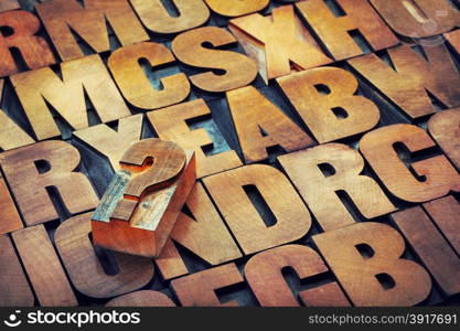 question mark and alphabet in vintage letterpress wood type printing blocks stained by color inks