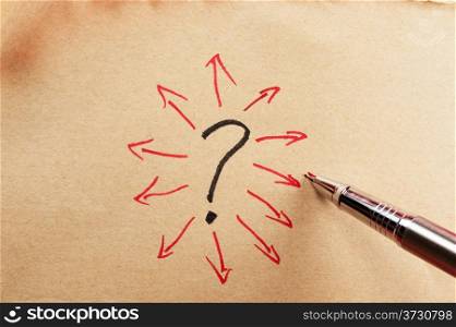 Question mark and group of arrows drawn on paper using a pen