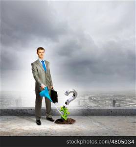 Question mark. Image of businessman watering green question mark