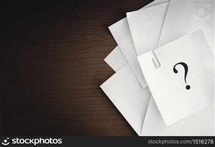 question mark on white notepad paper