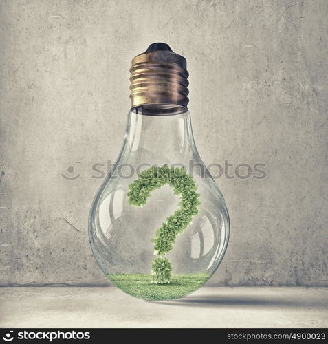 Question of ecology and energy saving. Green question mark inside glass light bulb