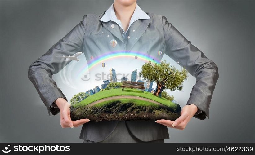 Question of environment and modern life. Green eco life of modern city presented in hands of businesswoman
