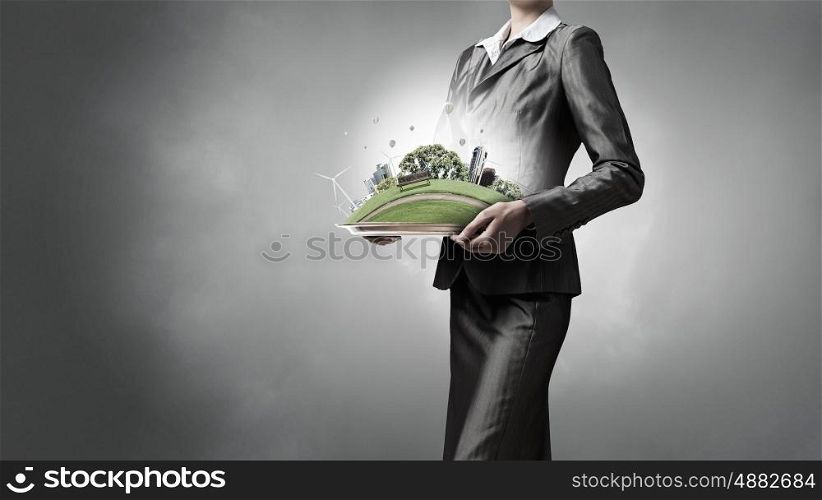 Question of environment and modern life. Green eco life of modern city presented in hands of businesswoman