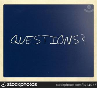""Questions?" handwritten with white chalk on a blackboard."