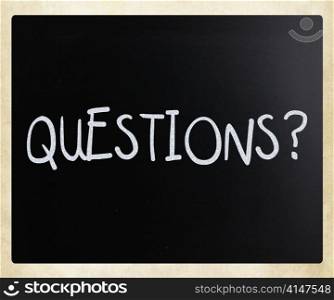""Questions?" handwritten with white chalk on a blackboard"