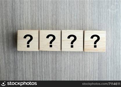 Questions Mark ( ? ) word with wooden cube block on table background. FAQ( frequency asked questions), Answer, Q&A, Information, Communication and Brainstorming Concepts