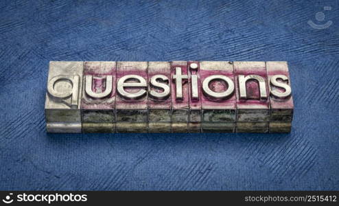 questions word in grunge letterpress metal type against blue textured paper, communication concept