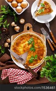 Quiche lorraine. Homemade savoury pie, tart with chicken meat, fried mushrooms and cheese. French cuisine.