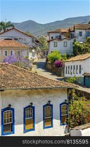 Quiet street with old colorful houses in colonial architecture, cobblestones and lanterns for lighting at Ouro Preto city. Quiet street with old colorful houses in colonial architecture, cobblestones and lanterns at Ouro Preto