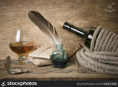 quill in the inkwell and glass of wine