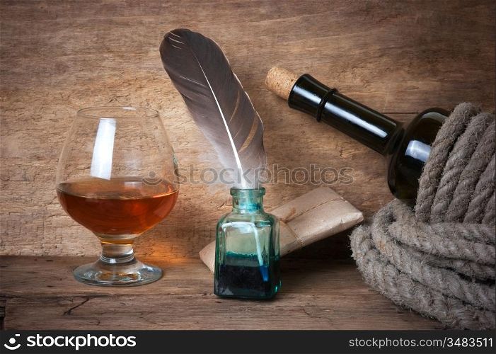 quill in the inkwell and glass of wine