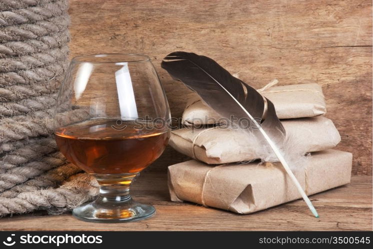 quill in the inkwell and glass of wine