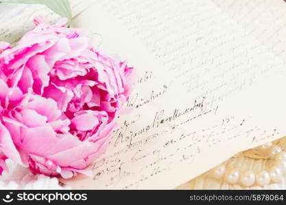 quill pen and antique letters. Pink peony flower with antique handwritten letter