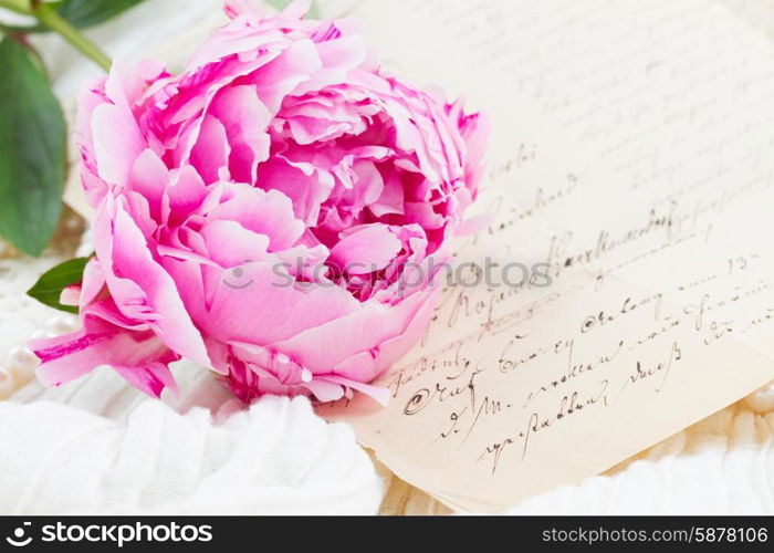 quill pen and antique letters. Pink peony with antique letter on white lace background